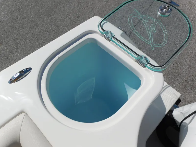 Slide: The Image of Livewell on 2024 Sailfish 242 CC boat with open glass lid. - 35