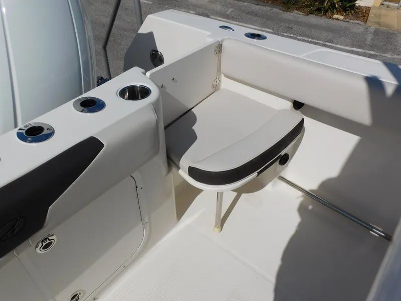 Slide: The Image of 2024 Sailfish 242 CC boat interior with foldable seat and cup holders. - 36