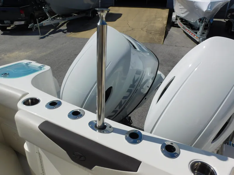 Slide: The Image of 2024 Sailfish 242 CC boat with dual Suzuki outboard engines. - 38