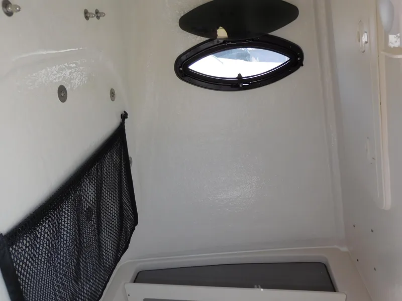 Slide: The Image of Interior cabin of 2024 Sailfish 242 CC boat with porthole and storage net. - 42