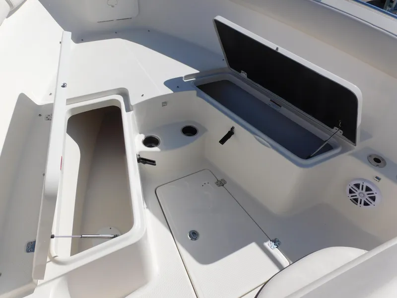 Slide: The Image of 2024 Sailfish 242 CC boat storage compartments and seating area. - 46