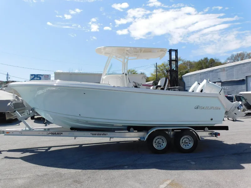 Slide: The Image of 2024 Sailfish 242 CC boat on a trailer in a marina. - 5