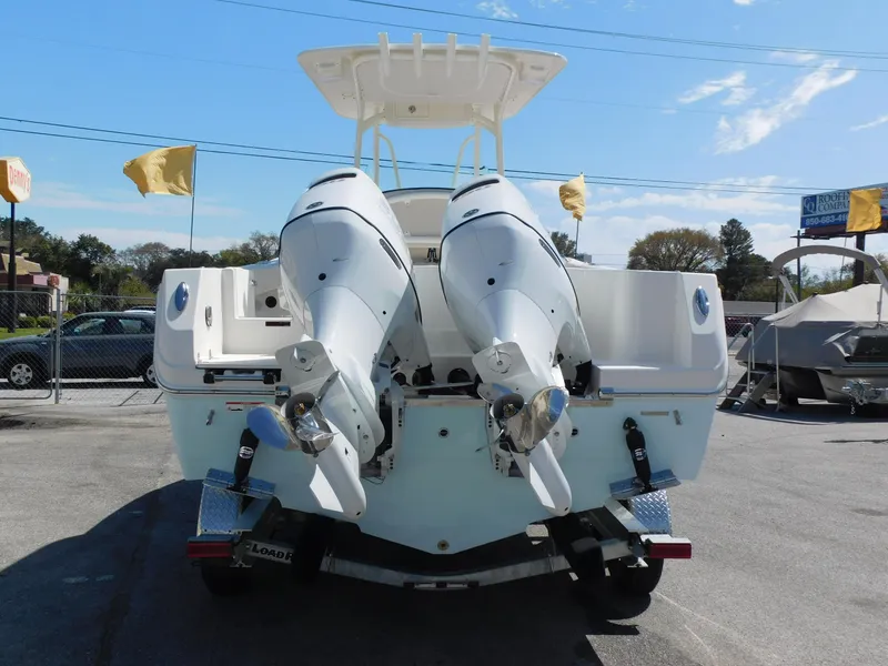 Slide: The Image of 2024 Sailfish 242 CC boat with twin outboard engines, rear view. - 6