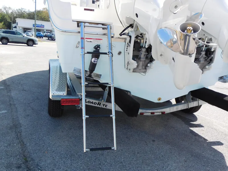 Slide: The Image of 2024 Sailfish 242 CC boat on Load Rite trailer with ladder and dual outboard motors. - 7