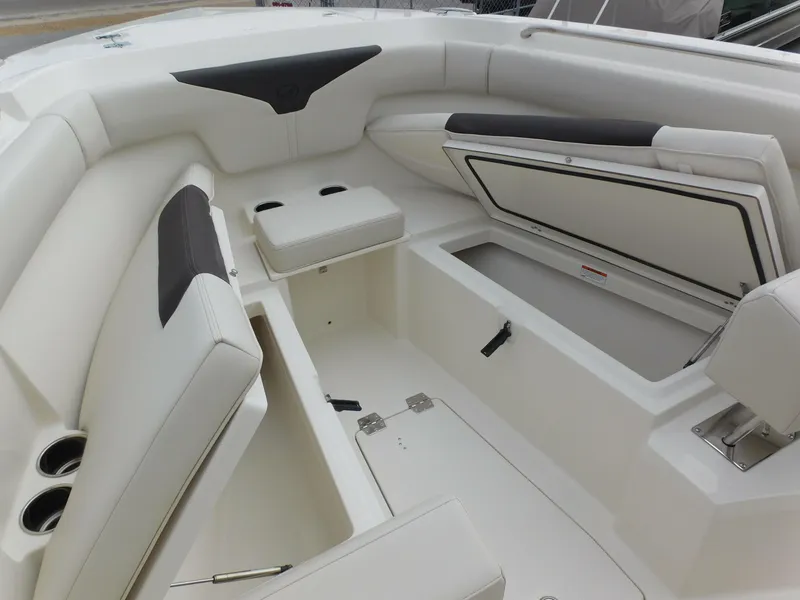 Slide: The Image of 2024 Sailfish 312 CC boat interior with open storage compartments and cushioned seating. - 12