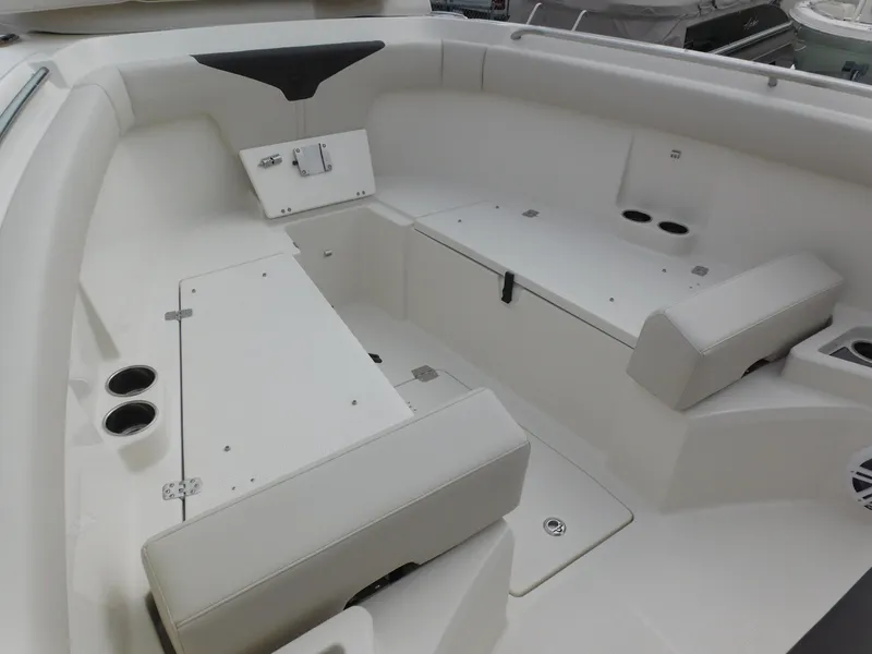 Slide: The Image of 2024 Sailfish 312 CC boat interior with seating and storage compartments. - 13
