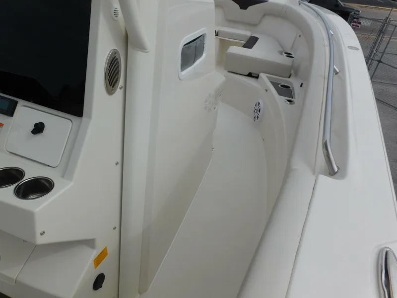 Slide: The Image of 2024 Sailfish 312 CC boat interior, white seating, and control panel. - 22