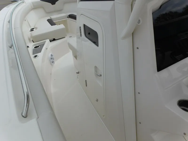 Slide: The Image of 2024 Sailfish 312 CC boat interior, featuring seating and storage compartments. - 23