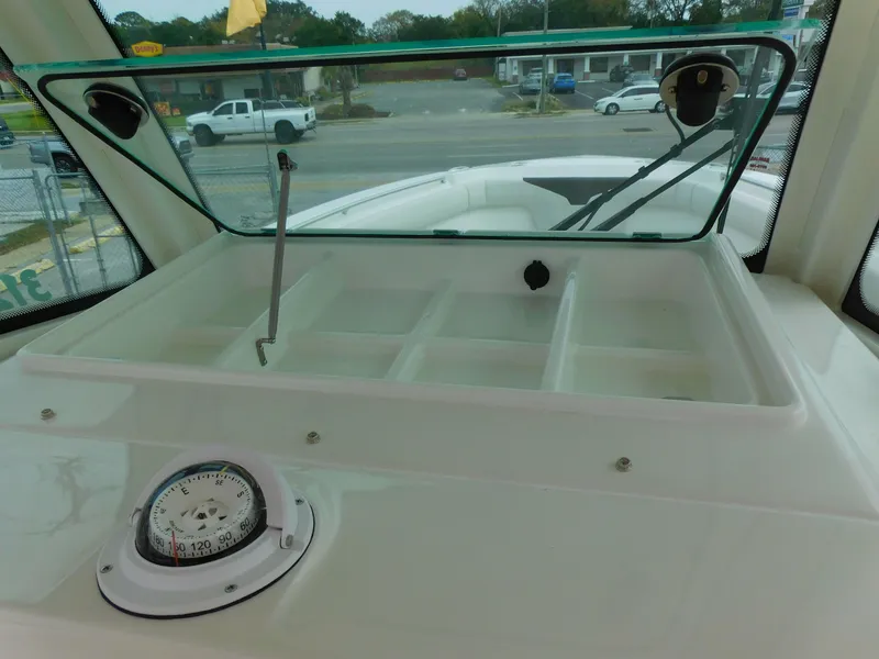Slide: The Image of 2024 Sailfish 312 CC boat console with compass and storage compartments. - 26