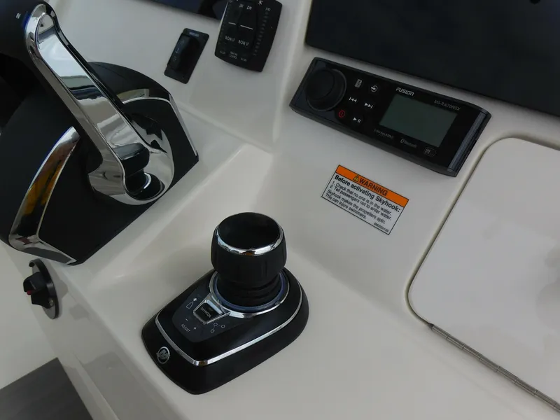 Slide: The Image of Close-up of 2024 Sailfish 312 CC boat control panel and joystick. - 28