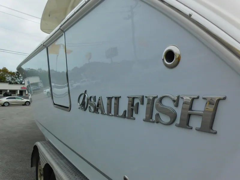 Slide: The Image of 2024 Sailfish 312 CC boat side view with logo. - 3