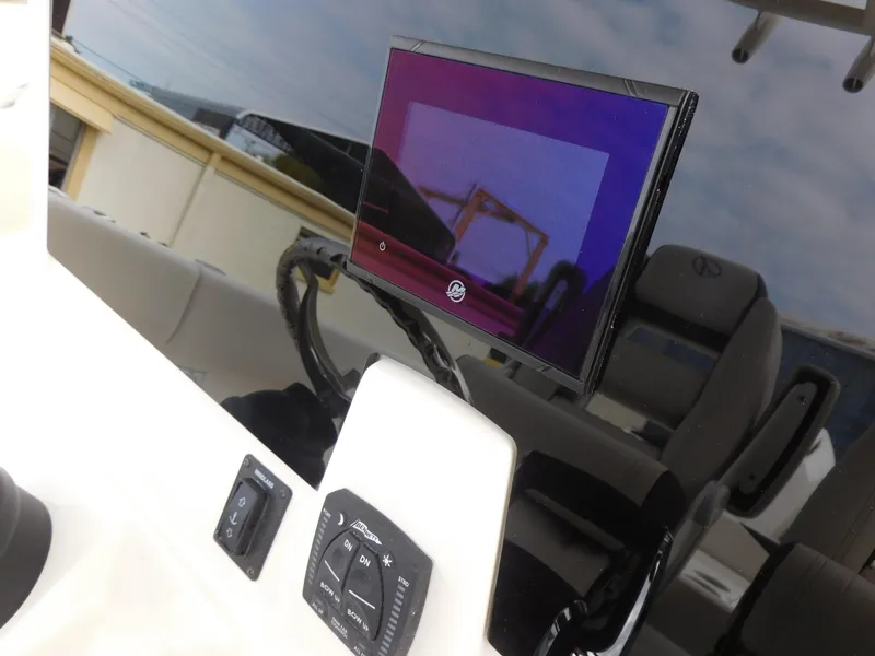Slide: The Image of 2024 Sailfish 312 CC boat dashboard with modern navigation screen and controls. - 31