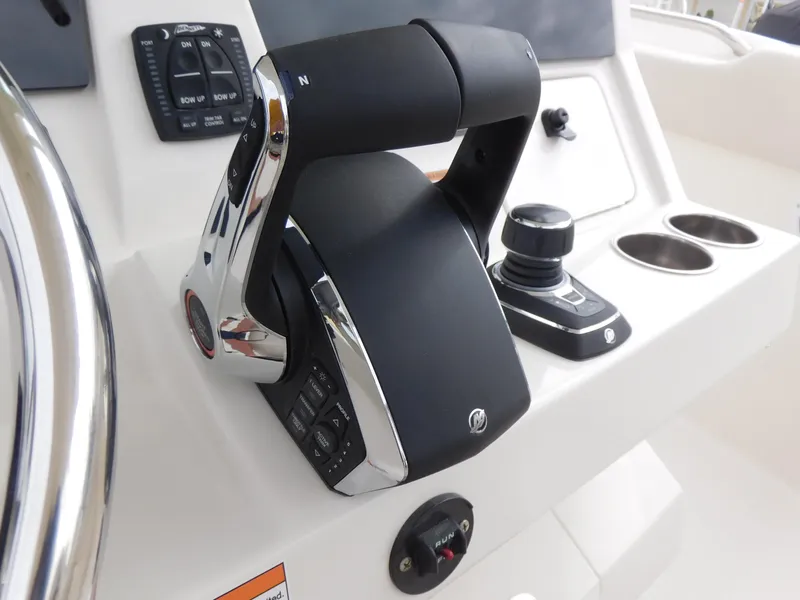 Slide: The Image of Close-up of the 2024 Sailfish 312 CC boat's control panel and throttle. - 32