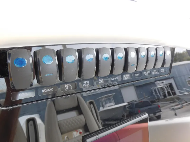 Slide: The Image of Control panel of 2024 Sailfish 312 CC boat with labeled switches. - 33