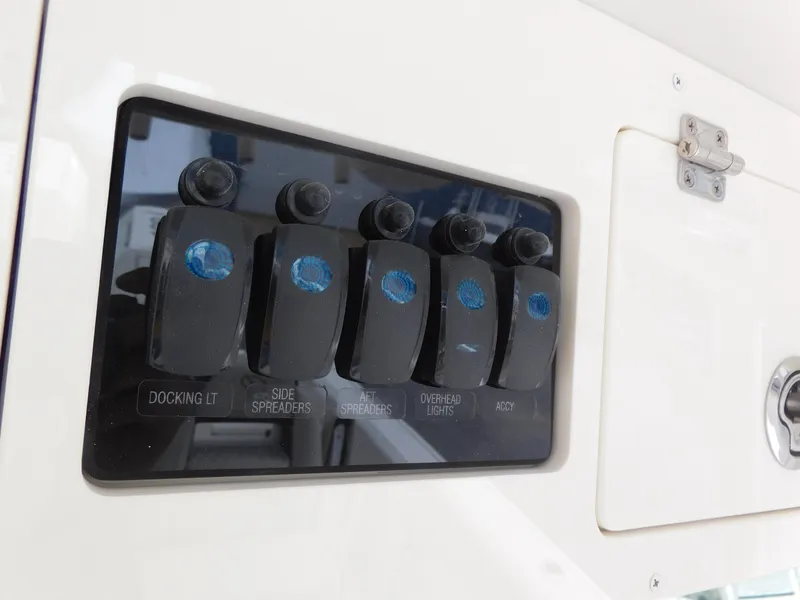 Slide: The Image of Control panel of 2024 Sailfish 312 CC boat with labeled switches. - 34