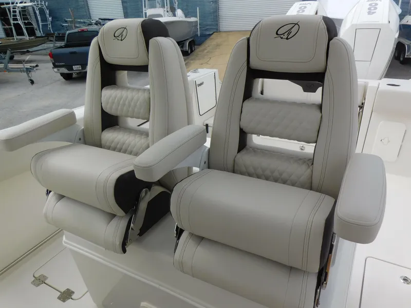 Slide: The Image of 2024 Sailfish 312 CC boat with luxurious dual captain's chairs. - 37