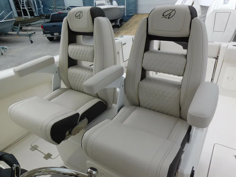 Slide: The Image of 2024 Sailfish 312 CC boat seats with armrests and diamond-stitched upholstery. - 38