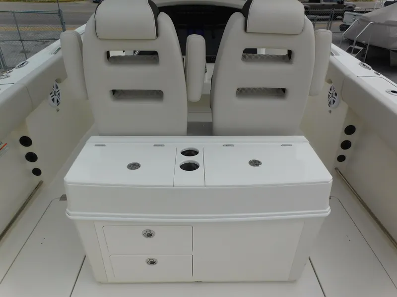 Slide: The Image of 2024 Sailfish 312 CC boat interior with dual seats and storage compartments. - 39