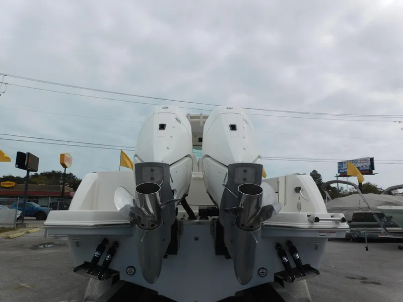 Slide: The Image of 2024 Sailfish 312 CC boat with dual outboard motors, rear view. - 4