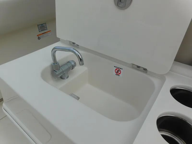 Slide: The Image of 2024 Sailfish 312 CC boat sink and faucet in the cockpit area. - 42