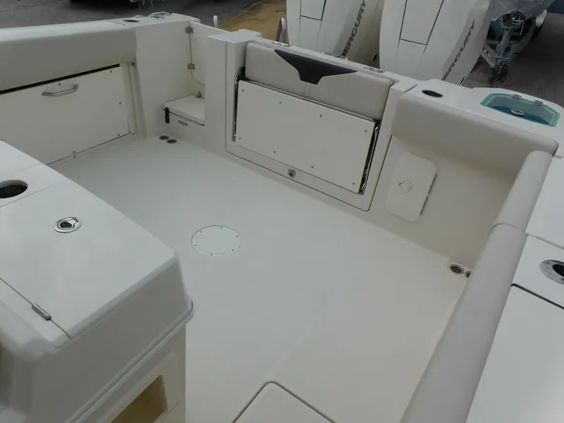Slide: The Image of 2024 Sailfish 312 CC boat deck with storage compartments and seating. - 44