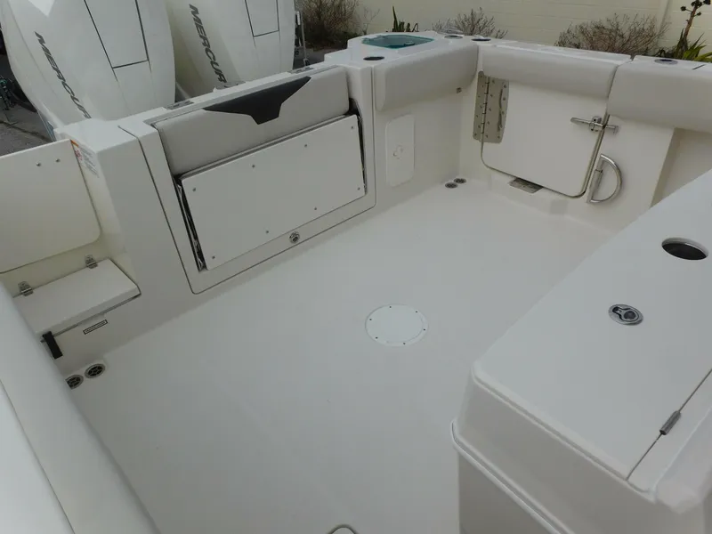 Slide: The Image of 2024 Sailfish 312 CC boat deck with storage compartments and twin Mercury engines. - 45