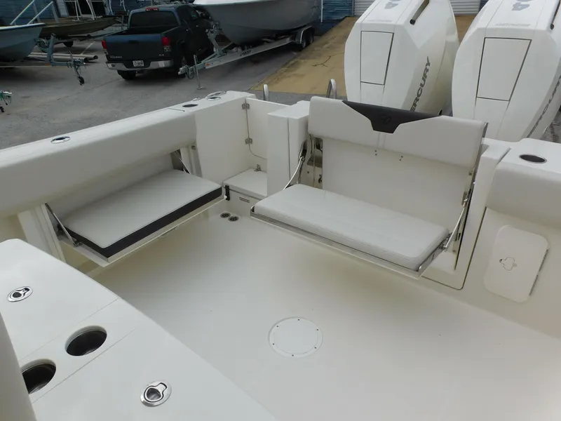 Slide: The Image of 2024 Sailfish 312 CC boat interior with foldable seating and twin Mercury outboard engines. - 46