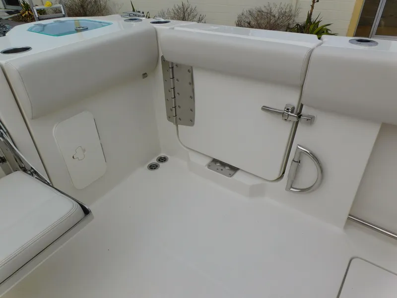 Slide: The Image of 2024 Sailfish 312 CC boat interior, featuring a clean, white deck and secure hatch. - 47