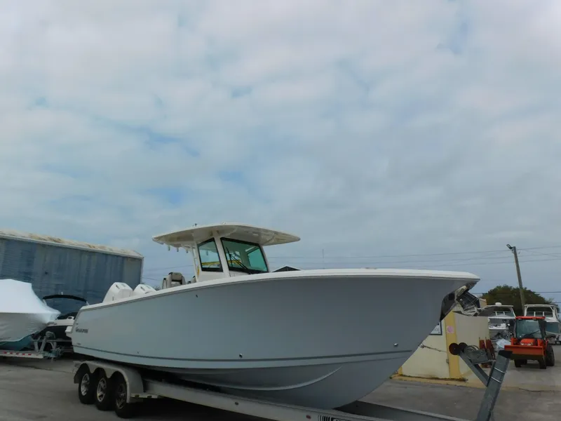 Slide: The Image of 2024 Sailfish 312 CC boat on a trailer in a marina. - 5