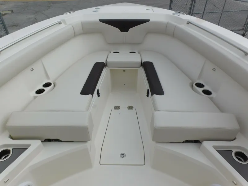 Slide: The Image of 2024 Sailfish 312 CC boat interior with cushioned seating and storage compartments. - 8