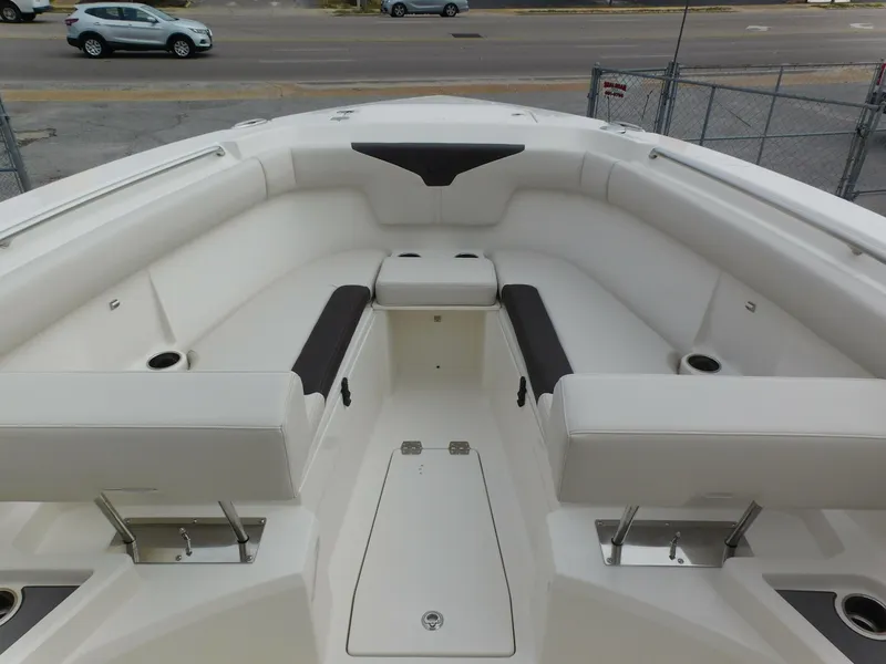 Slide: The Image of 2024 Sailfish 312 CC boat interior with white cushioned seating. - 9