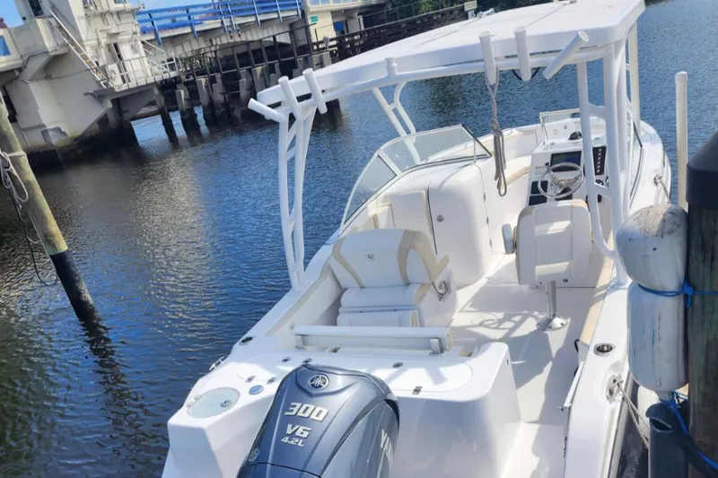 Slide: The Image of 2022 Century Resorter boat docked by a bridge, featuring a Yamaha 300 V6 engine. - 4