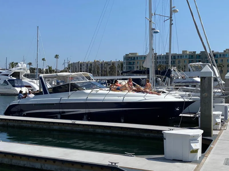 The Image of 1993 Silverton 38 Express yacht docked at marina with people sunbathing. - 1