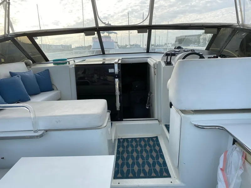 Slide: The Image of 1993 Silverton 38 Express boat interior with seating and helm station. - 14