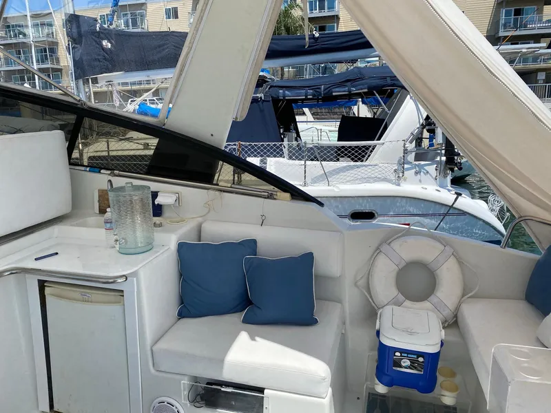 Slide: The Image of 1993 Silverton 38 Express yacht interior with seating, cushions, and life preserver. - 9