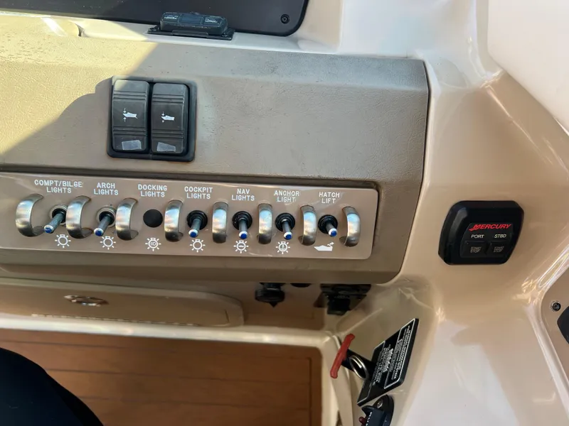 Slide: The Image of Control panel of a 2012 Sea Ray 300 SLX boat with labeled switches. - 24