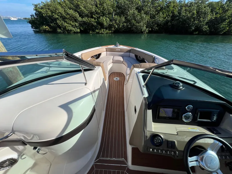 Slide: The Image of 2012 Sea Ray 300 SLX boat interior with sleek dashboard and spacious seating. - 27