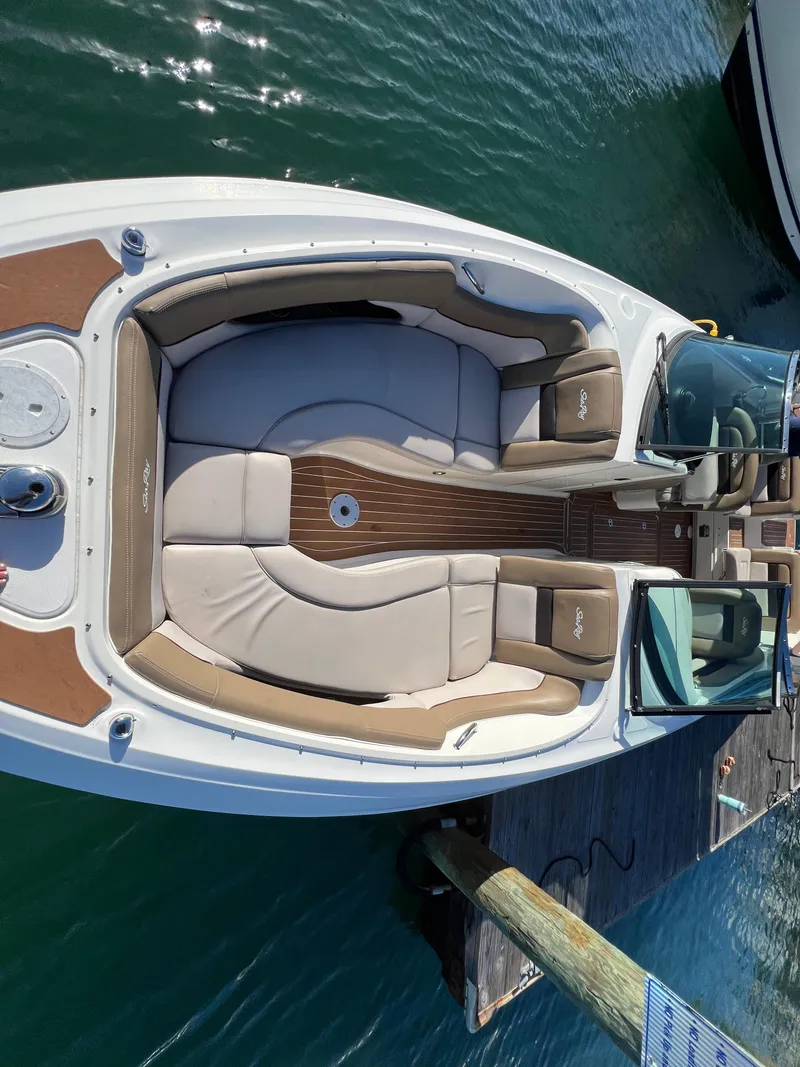Slide: The Image of 2012 Sea Ray 300 SLX boat with spacious seating, docked on calm water. - 29