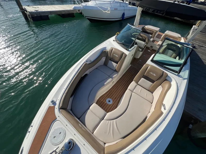 Slide: The Image of 2012 Sea Ray 300 SLX boat with spacious seating at a marina. - 30