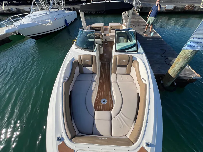 Slide: The Image of 2012 Sea Ray 300 SLX boat docked, featuring spacious seating and sleek design. - 31