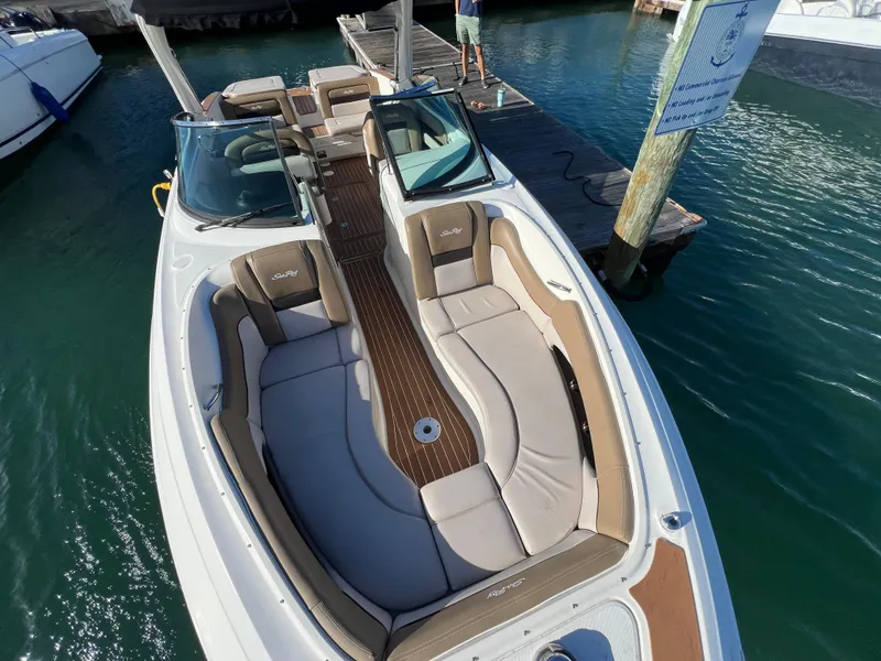 Slide: The Image of 2012 Sea Ray 300 SLX boat docked, featuring spacious seating and sleek design. - 32
