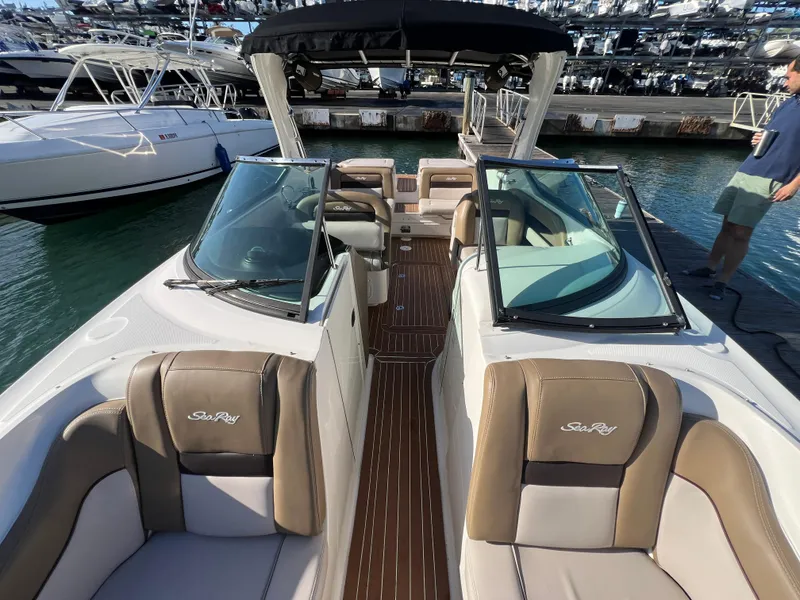 Slide: The Image of 2012 Sea Ray 300 SLX boat with tan seating and open deck, docked at marina. - 34