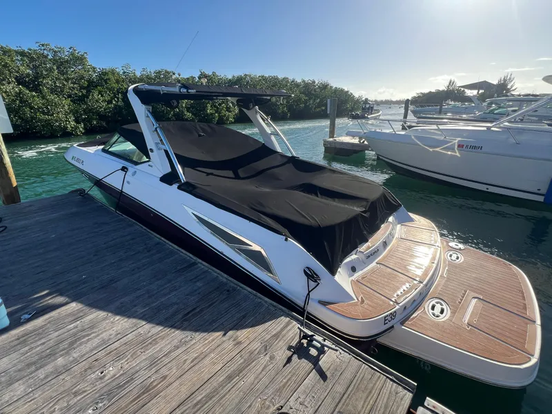 Slide: The Image of 2012 Sea Ray 300 SLX boat docked, covered, in sunny marina setting. - 46