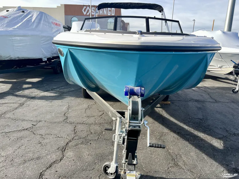 Slide: The Image of 2024 Bayliner M19 boat on a trailer, displayed outdoors. - 1