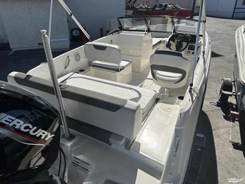 Slide: The Image of 2024 Bayliner M19 boat interior with seating and Mercury engine. - 5