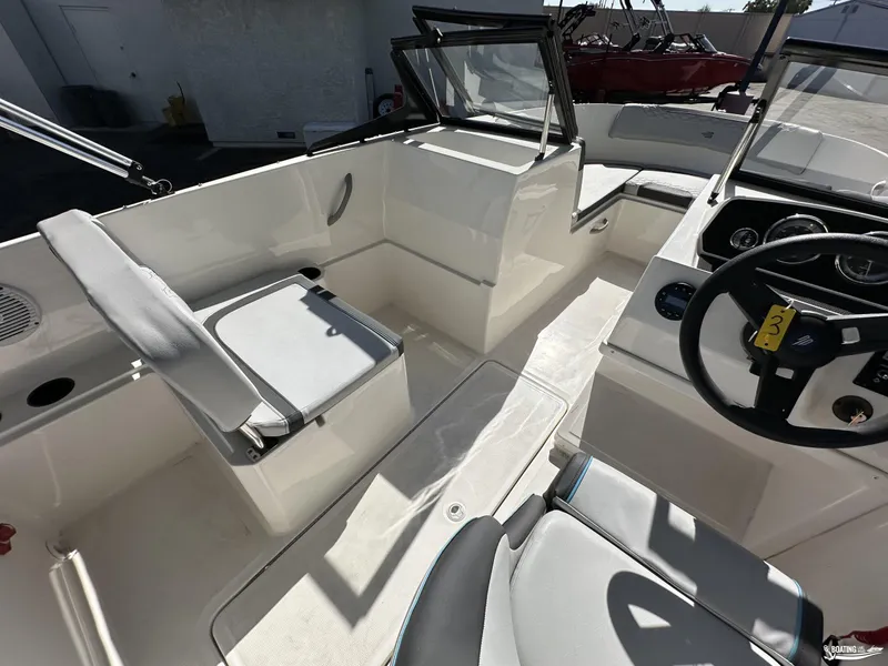 Slide: The Image of 2024 Bayliner M19 boat interior with seating and steering wheel. - 6