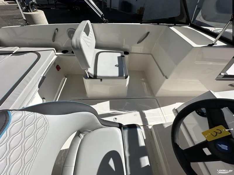 Slide: The Image of 2024 Bayliner M19 boat interior with modern seating and steering wheel. - 7