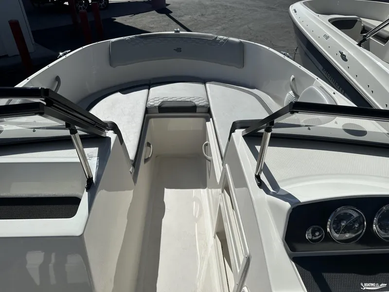 Slide: The Image of 2024 Bayliner M19 boat interior with seating and dashboard view. - 8