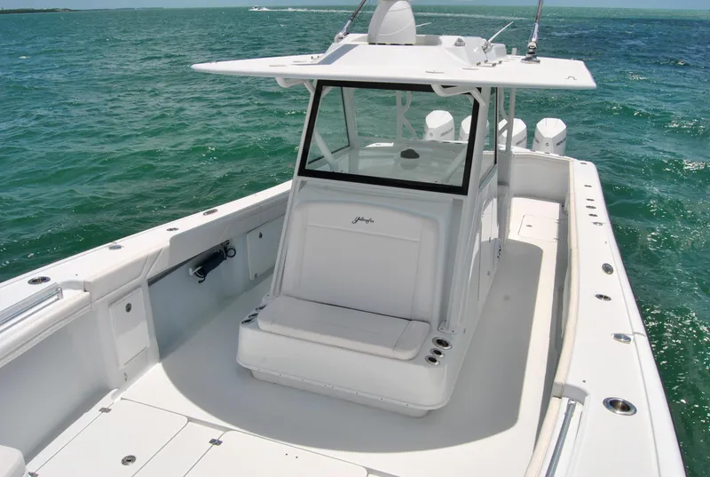 Slide: The Image of 2022 Yellowfin 39 Offshore boat on open water, showcasing spacious deck and sleek design. - 13