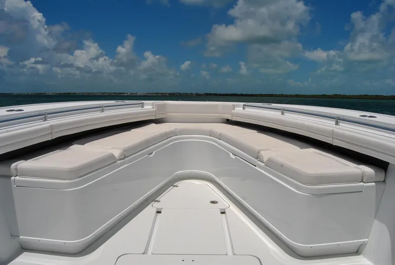 Slide: The Image of 2022 Yellowfin 39 Offshore boat with spacious seating under a clear blue sky. - 16